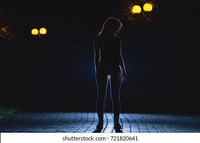 The Woman Stand On The Dark Alley. Night Time