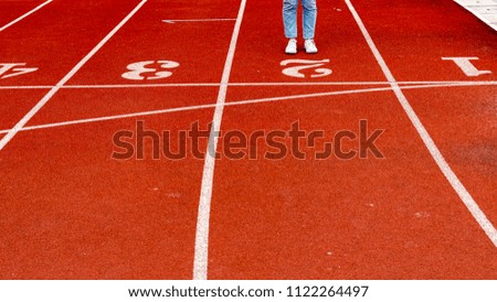 Woman stand on red running track. Business concept background.Spot concept banner background.