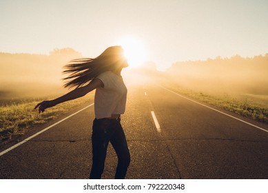 woman stand on the road with tree around, Asian traveler girl stand turn back on the road with sunshine and tree of parkland
