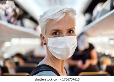 Woman Standing In The Airplane Wearing Face Mask