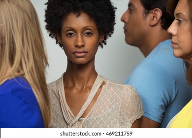 Woman Standing Alone In A Crowd.