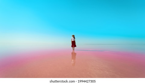 Woman Standing In Beautiful Mirror Reflection On Blue Sky On Sivash Pink Lake