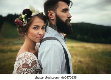 Woman Standing Behind Man And Looking At Camera