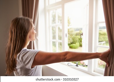 Woman Standing By Bedroom Window And Opening Curtains - Powered by Shutterstock