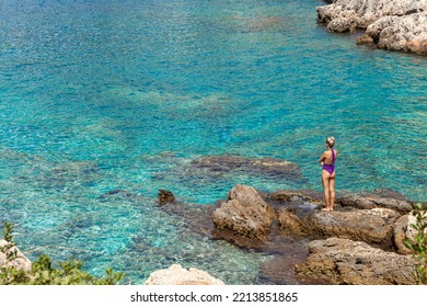 Woman Standing By The Sea In A Turquoise Bay