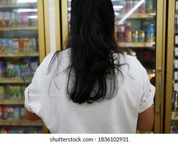 Woman Standing In Front Of Freezer In Supermarket,Business Concept.