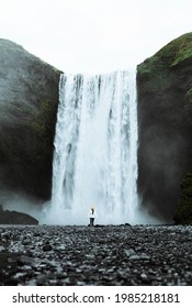 Woman Standing In Front Of Skógafoss Waterfall, Iceland