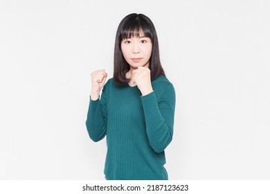 A Woman Standing In Front Of A White Background And Doing A Boxing Pose