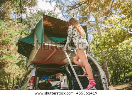 Similar – Image, Stock Photo Woman standing in ladder opening tent over car