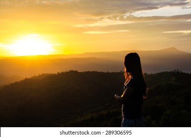 Woman Standing Mountain Watching The Sunrise