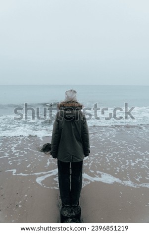 Similar – Senior sportswoman looking at the sea