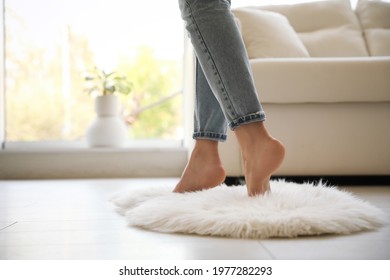 Woman Standing On Faux Fur Rug In Living Room, Closeup. Space For Text