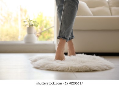 Woman Standing On Faux Fur Rug In Living Room, Closeup. Space For Text