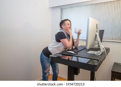 Woman Standing On Her Mat In Home Office Working At The Stand Up Ergonimc Desk