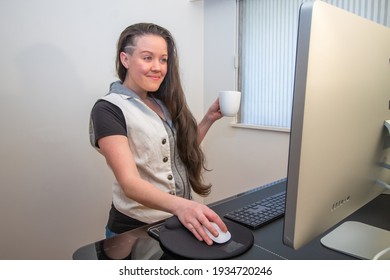 Woman Standing On Her Mat In Home Office Working At The Stand Up Ergonimc Desk