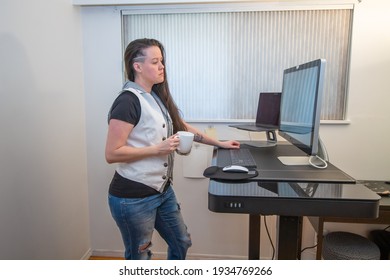 Woman Standing On Her Mat In Home Office Working At The Stand Up Ergonimc Desk