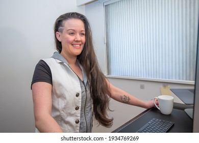 Woman Standing On Her Mat In Home Office Working At The Stand Up Ergonimc Desk