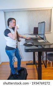 Woman Standing On Her Mat In Home Office Working At The Stand Up Ergonimc Desk