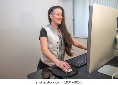 Woman Standing On Her Mat In Home Office Working At The Stand Up Ergonimc Desk