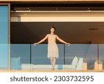 Woman standing on luxury balcony