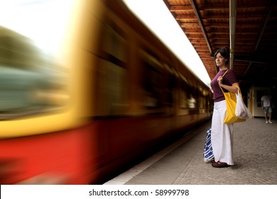 Woman Standing On The Platform Of An Underground Train