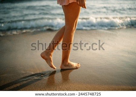 woman standing on shore at beach.