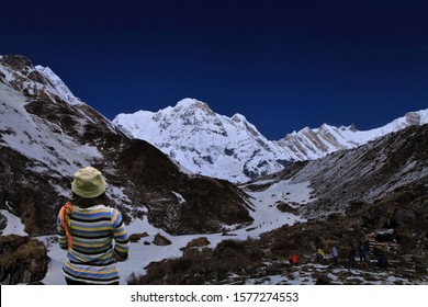 Woman Standing On Snow,Trekker Walking  Mountain Peak On The Annapurna Base Camp Trekking Route,abc Mountain Nepal.