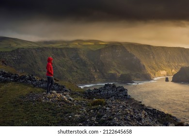 Woman Standing On A Top Of A Clif And Enjoying The View, Azores Island.