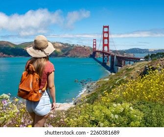 Woman standing on top of the mountain enjoying beautiful view. Girl sightseeing on summer vacation trip.  Golden Gate Bridge, over Pacific Ocean and San Francisco Bay, California, USA - Powered by Shutterstock