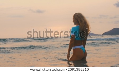 Woman standing on water sea. Girl stand in turquoise swimsuit. Freedom paradise holiday vacation summer beach, seaside landscape concept