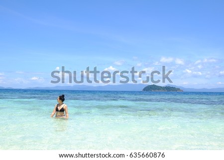 Woman is standing in the sea. Relax.