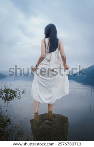 Similar – Image, Stock Photo Woman standing in shallow water with bare legs talking to her dog