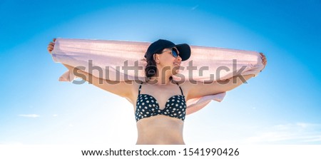 Similar – Brunette surfer woman in bikini standing with surfboard