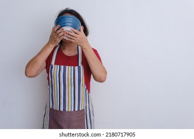 Woman Standing Wearing Apron Sipping A Bowl Of Soup 