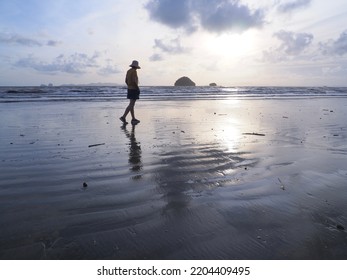 A Woman Is Standingting On The Beach After The Rain. Pak Meng Beach, Trang, Thailand, Leisure Outdoor Lifestyle Tourist Travel Trang Phuket Thailand, Tourism Beautiful Destination Place Asia