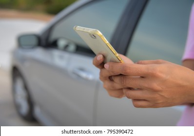 The Woman Stands By The Phone Beside His Car.