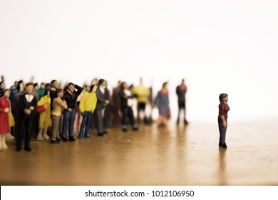 Woman Stands In Front Of Crowd Or Mob. Large Group Of People Vs. One Individual.  There Are Leaders And Followers. One Against Many. Stand Apart From The Crowd.