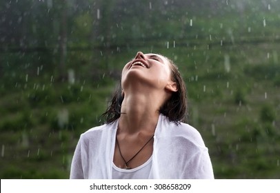 woman stands under the rain