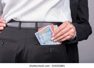 Woman Stealing Money In The Back Pocket Of Her Lover