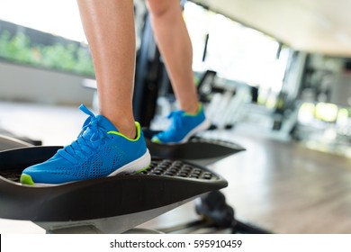 Woman Step On Elliptical Machine 