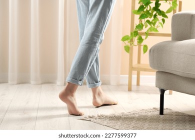 Woman stepping barefoot in room at home, closeup. Floor heating - Shutterstock ID 2277599377