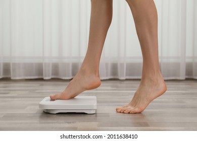 Woman Stepping On Floor Scales Indoors, Closeup. Weight Control