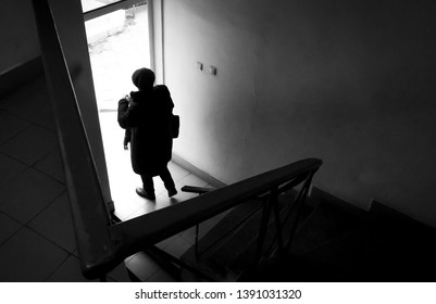 Woman Stepping Through A Doorway In Street Photography. Black White Photography And A Woman Shot In The Back.