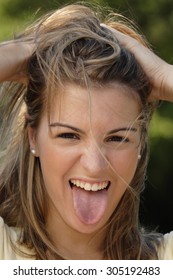 Woman Sticking Out Tongue In Fun.