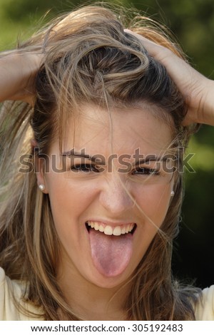 Woman sticking out tongue in fun.