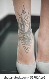 Woman In Stiletto Heels Shoes With Tattoo On The Ankle.