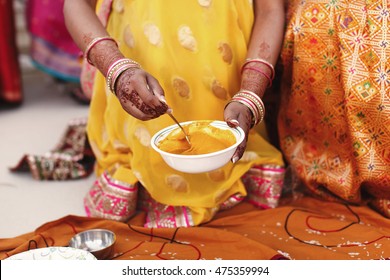 Woman Stirs Turmeric Paste In The White Bowl