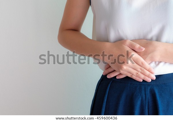 woman stomach\
ache because of gastritis or menstruation that are sign of stomach\
trouble with grey background\
tone
