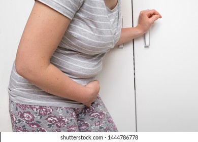 Woman with stomach ache or menstrual pains - abdominal pain concept