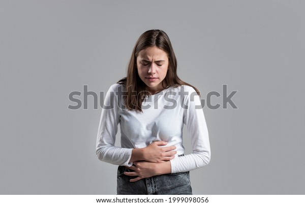 Woman Stomach Ache. Woman\
touching his stomach. Stomach pain and others stomach disease\
concept.Girl having a stomachache. Young woman suffering from\
abdominal pain.